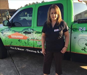 female employee in front of SERVPRO truck