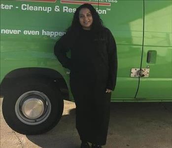 female employee in front of SERVPRO truck