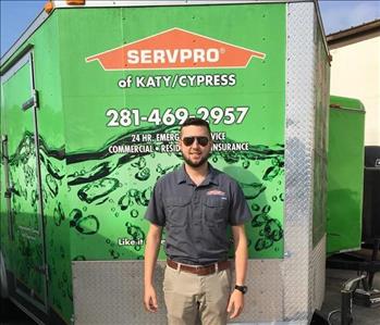 Male employee in front of SERVPRO truck